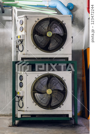 Air conditioner compressor installed in old building. Air conditioner compressor installed in old building. 123472244