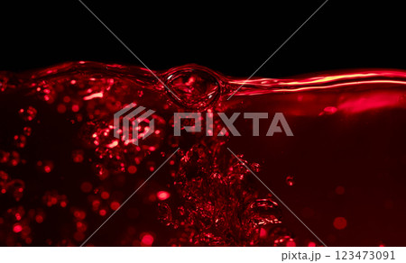Red wine on a black background, abstract splashing. Red wine on a black background, abstract splashing. 123473091