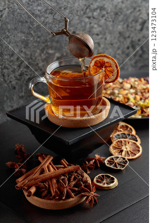 Cup of herbal tea with ingredients and slices of dried orange slices. Cup of herbal tea with ingredients and slices of dried orange slices. 123473104
