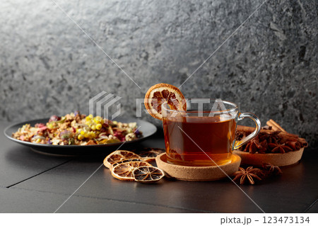 Cup of herbal tea with ingredients and slices of dried orange slices. Cup of herbal tea with ingredients and slices of dried orange slices. 123473134