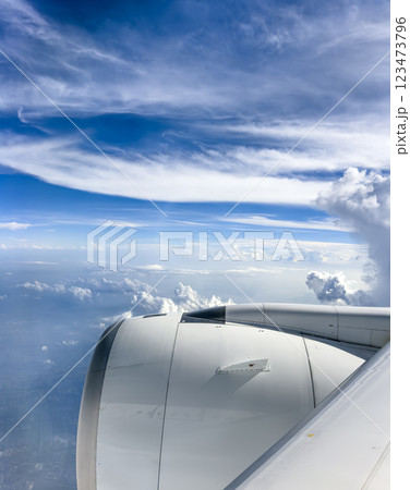 Cloud formations viewed from an airplane window during daytime flight Cloud formations viewed from an airplane window during daytime flight 123473796