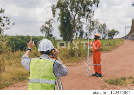 Engineer surveyor team Use drone for operator inspecting and survey construction site Engineer surveyor team Use drone for operator inspecting and survey construction site 123473804