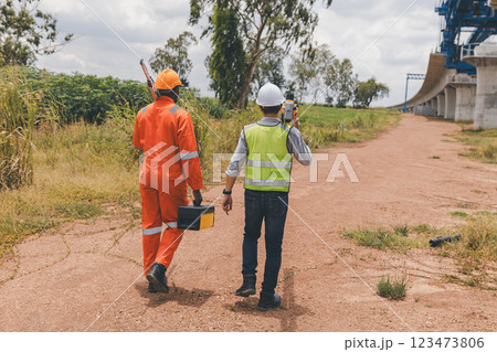 Engineer surveyor team Use drone for operator inspecting and survey construction site 123473806
