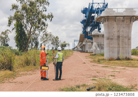 Engineer surveyor team Use drone for operator inspecting and survey construction site 123473808
