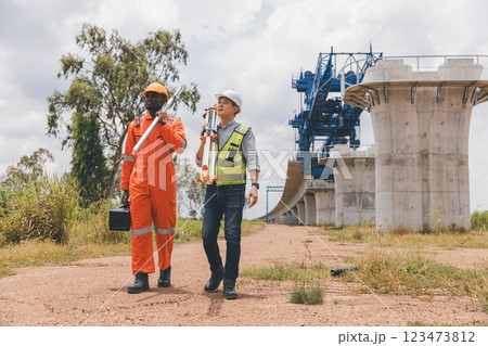 Engineer surveyor team Use drone for operator inspecting and survey construction site Engineer surveyor team Use drone for operator inspecting and survey construction site 123473812