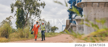 Engineer surveyor team Use drone for operator inspecting and survey construction site 123473816