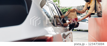 Hand Man in car receiving coffee in drive thru fast food restaurant. Hand Man in car receiving coffee in drive thru fast food restaurant. 123473894