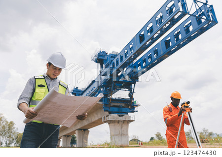 Engineer surveyor team Use drone for operator inspecting and survey construction site. 123474430