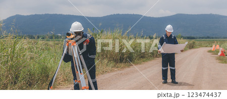 Engineer surveyor team Use drone for operator inspecting and survey construction site. 123474437