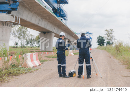 Engineer surveyor team Use drone for operator inspecting and survey construction site. Engineer surveyor team Use drone for operator inspecting and survey construction site. 123474440
