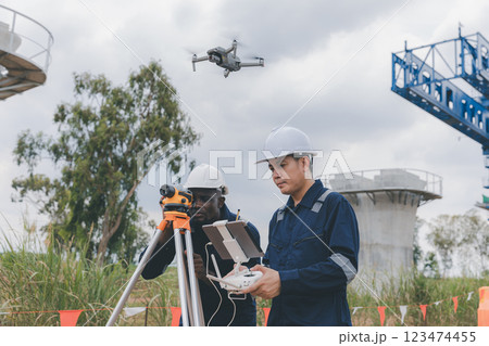 Engineer surveyor team Use drone for operator inspecting and survey construction site. 123474455