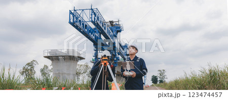 Engineer surveyor team Use drone for operator inspecting and survey construction site. Engineer surveyor team Use drone for operator inspecting and survey construction site. 123474457