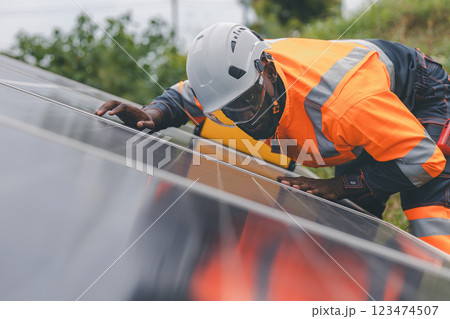 Engineer Checking solar panels in agriculture farm land. Engineer Checking solar panels in agriculture farm land. 123474507