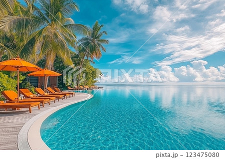 Stunning landscape, swimming pool blue sky with clouds. Tropical resort hotel in Maldives. Fantastic relax and peaceful vibes, chairs, loungers under umbrella and palm leaves. Luxury travel vacation Stunning landscape, swimming pool blue sky with clouds. Tropical resort hotel in Maldives. Fantastic relax and peaceful vibes, chairs, loungers under umbrella and palm leaves. Luxury travel vacation 123475080