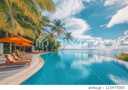 Stunning landscape, swimming pool blue sky with clouds. Tropical resort hotel in Maldives. Fantastic relax and peaceful vibes, chairs, loungers under umbrella and palm leaves. Luxury travel vacation 123475083