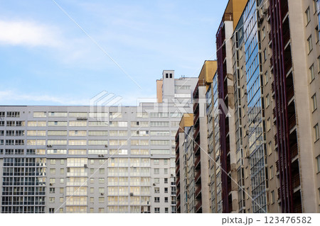 A long row of impressive tall buildings set against a clear blue sky 123476582