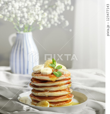 Delicious Pancakes Artfully Topped with banana slices and Golden Honey Delicious Pancakes Artfully Topped with banana slices and Golden Honey 123477143