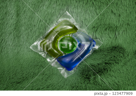 Washing gel capsule on material textile background Washing gel capsule on material textile background 123477909
