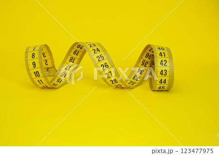 Spiral tape measure colorful background with copyspace 123477975