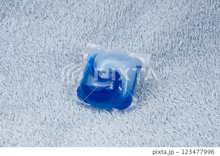 Washing gel capsule on material textile background 123477996