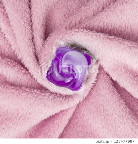 Washing gel capsule on material textile background 123477997