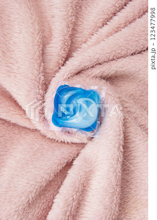 Washing gel capsule on material textile background 123477998