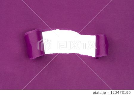 Hole in paper purple background torn damaged for design 123478190