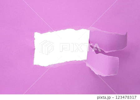 Hole in paper pink background torn damaged for design 123478317
