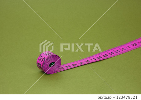 Colorful tape measure spiral with copyspace background Colorful tape measure spiral with copyspace background 123478321