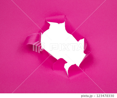 Hole in paper pink background torn damaged for design Hole in paper pink background torn damaged for design 123478330