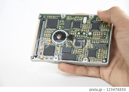 2.5 inch hard disk. Technician holding hard disk on white background. 123478850