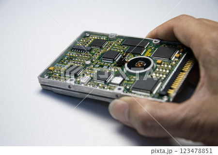 2.5 inch hard disk. Technician holding hard disk on white background. 123478851