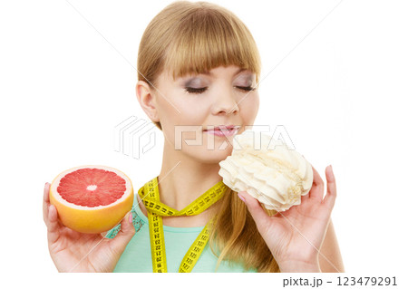 Woman choosing fruit or cake make dietary choice 123479291