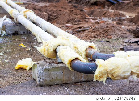 There are a couple of pipes that have been covered in insulation There are a couple of pipes that have been covered in insulation 123479848