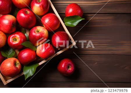 Fresh red apples in wooden crate on brown wooden background Fresh red apples in wooden crate on brown wooden background 123479976