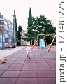 Little girl in a tracksuit runs on the playground. High quality photo 123481225