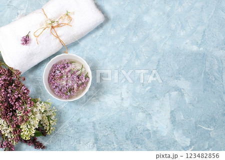 Spa and wellness composition with lilac flowers aromatic water in porcelain bowl on blue background, aromatherapy and skin and body care, flat lay, top view, lifestyle concept and modern woman, 123482856