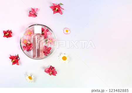 Bottles with lotion with archidea extract for the body and petri dishes with flowers on a pink background, the concept of natural organic cosmetics, advertising for spa and store, top view Bottles with lotion with archidea extract for the body and petri dishes with flowers on a pink background, the concept of natural organic cosmetics, advertising for spa and store, top view 123482885