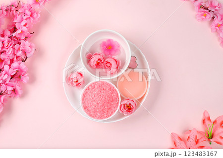 Spa ingredients with fragrant rose water, sea salt, rose and sakura flowers, skin and body care, aromatherapy, lifestyle concept, card for invitation and advertising, selective focus, place for text 123483167