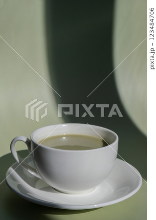 Green latte matcha on pastel background with creative deep shadows. Concept of holiday breakfast morning tea drink. Cozy minimalist superfood vibrant colors healthy eating. Organic caffeine-free Green latte matcha on pastel background with creative deep shadows. Concept of holiday breakfast morning tea drink. Cozy minimalist superfood vibrant colors healthy eating. Organic caffeine-free 123484706