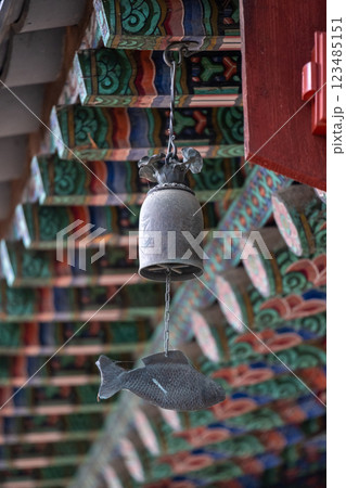 Punggyeong, a wind chime in fish shape. It is often placed near entryways in Korean buildings for protection and as a reminder of Buddhist teachings 123485151