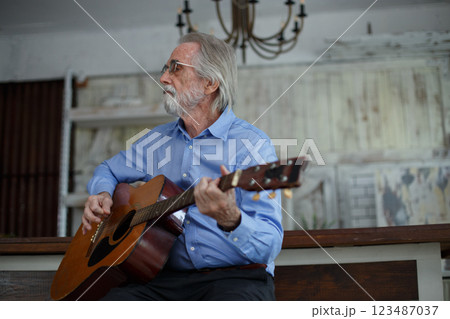 Elderly man play guitar instrument. grandfather mature pensioner relax retired song fun lifestyle generation musician. Elderly man play guitar instrument. grandfather mature pensioner relax retired song fun lifestyle generation musician. 123487037