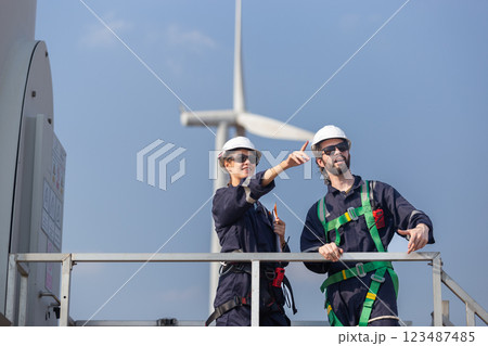 Team engineer wind turbine worker safety uniform survey discuss operational planning windmill field clean energy. Alternative technology protect environment reduce global warming problems. Team engineer wind turbine worker safety uniform survey discuss operational planning windmill field clean energy. Alternative technology protect environment reduce global warming problems. 123487485