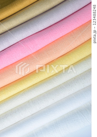 stack of colourful cotton clothes, pile of clothing on white background 123488248