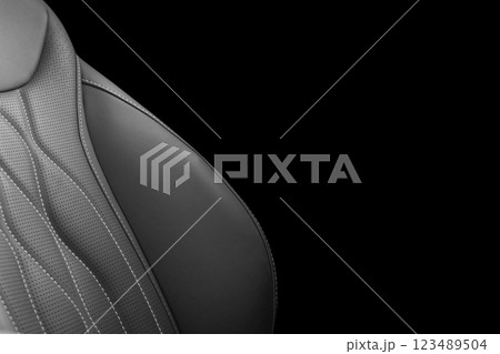 Black leather interior of the luxury modern car. Perforated black leather. Seats with stitching isolated on black background. Modern car interior details. Car inside Black leather interior of the luxury modern car. Perforated black leather. Seats with stitching isolated on black background. Modern car interior details. Car inside 123489504