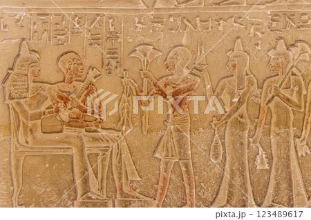 Ancient egyptian paintings and hieroglyphs carved on the stone wall 123489617