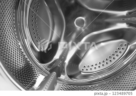 Washing machine drum close up. Washing machine background. Inside the washing machine. Metal washing machine drum. 123489705