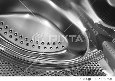 Washing machine drum close up. Washing machine background. Inside the washing machine. Metal washing machine drum. Washing machine drum close up. Washing machine background. Inside the washing machine. Metal washing machine drum. 123489706
