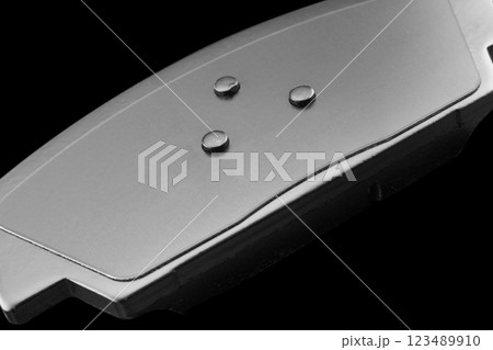 Brake pads isolated on black background. Auto parts. Brake pads isolated on black. Braking pads. Car part. Car detailing. Spare parts 123489910