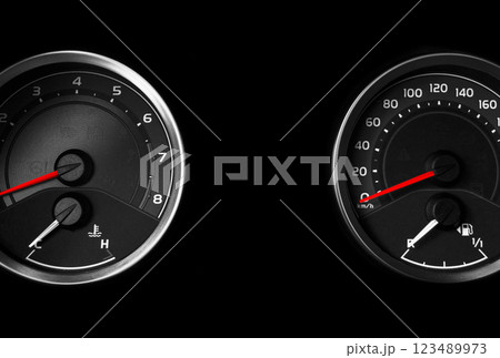 Close up shot of a speedometer in a car. Car dashboard. Dashboard details with indication lamps.Car instrument panel. Dashboard with speedometer, tachometer, odometer. 123489973